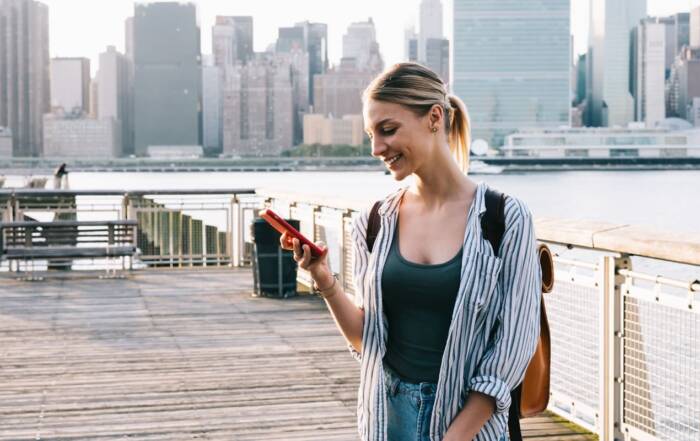 Mujer con su teléfono móvil en la mano en Nueva York en Estados Unidos.